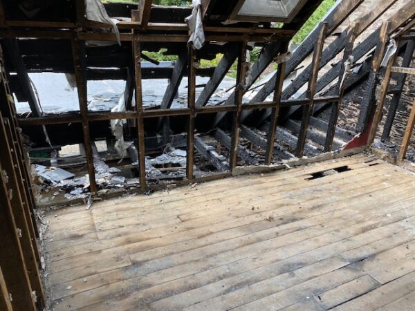 Internal view of room with exposed beams on walls and floor. House Fire Insurance Reinstatement Lanark