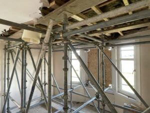 Internal view of scaffold inside the house. One of the bay windows is boarded up. emergency make-safe blog